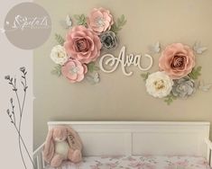 there is a crib with flowers on the wall and a stuffed animal next to it