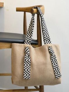 a black and white bag sitting on top of a wooden chair