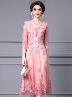 Mingle in style with this elegant mother of the bride dress, designed to make you feel special on such a memorable day. The delicate pink color is both flattering and romantic, perfect for a joyous celebration. This dress features intricate floral embroidery that covers the bodice and skirt, adding a touch of whimsy and femininity. The deep V-neckline is tastefully embellished with beadwork, enhancing the dressoverall elegance. The three-quarter sleeves provide a modest yet stylish look, suitabl Blush Pink Mother Of The Bride Dress Mom, Spring Pink Dress With Intricate Embroidery, Pink Lace Dress, Pink Embroidered V-neck Dress, Pink V-neck Mother Of The Bride Dress, Elegant Pink V-neck Mother Of The Bride Dress, Pink Floor-length Mother Of The Bride Dress, Short Sleeve Prom Dresses, High Neck Prom Dress