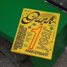 a yellow book sitting on top of a green bench