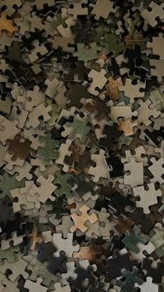 a large pile of puzzle pieces sitting on top of each other