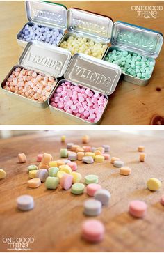 there are many different candies in the tins on the table and one is filled with them