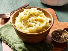 mashed potatoes in a bowl on a cutting board