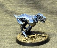 a small metal dinosaur model on a table