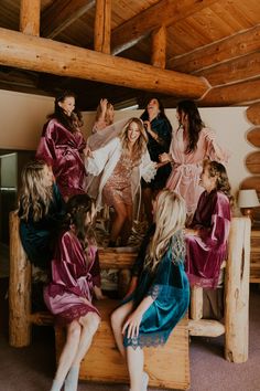 a group of women sitting around each other in robes