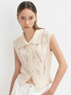 This product is a stylish knit vest that features a distressed design, adding a contemporary edge to a traditional piece. It includes a button-up front, which allows for versatility in styling as it can be worn open or closed. The vest is crafted with a soft, textured fabric that adds depth and interest to its overall appearance. - This vest is made from a unique blend of fibers that create a soft and comfortable feel against the skin.- The distressed detailing provides a modern, urban look, ideal for layering over shirts or dresses.- It features a series of functional buttons that can be fastened for a snug fit or left open for a more relaxed style.- The textured fabric not only enhances visual appeal but also contributes to the garment’s durability. Casual Sleeveless Cardigan With Button Closure, Sleeveless Knit Vest With Button Closure, Sleeveless Knit Sweater Vest With Buttons, Spring Knit Sweater Vest With Buttons, Knit Sweater Vest With Button Closure For Spring, Spring Knit Sweater Vest With Button Closure, Urban Looks, Modern Urban, Sweaters Knitwear