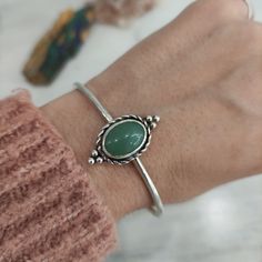 "This sterling silver cuff is completely handmade in our workshop, such as all our products.  The thickness of wire is 2,5mm and the stone is a green natural aventurine.q The sizes we offer below refer to wrist measurement. If you want other size, please send me a message before your purchase. All my items are handmade from start to finish in Greece. Come in a beautiful gift package with \"κοσμώ\" message card.  Thank you for visiting, check my full collection here: https://www.etsy.com/shop/kosmojewellery HOW TO CARE FOR YOUR STERLING SILVER JEWELLERY: Any substance that isn't PH neutral can potentially affect your jewellery. Cosmetics, perfumes, lotion and everything that contains chemicals can damage your jewellery. So, I recommend that you always make sure to take off your jewellery be Aventurine Bracelet, Men Bracelets, Pink Tourmaline Ring, Form Design, Gift Package, Sterling Silver Cuff Bracelet, Gold Hands, Statement Bracelet, Stunning Necklace