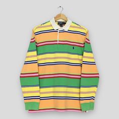 Vintage Polo Ralph Lauren Striped Rugby Shirt Large Polo Ralph Lauren Collared Shirt Ralph Lauren Multicolor Stripes Rugby Polo Shirt Size L Good Used Condition. Have minor stains, REFER PICTURE. Size (On Tag) : Size L **To make sure if it FITS YOU, refer at the exact measurements. Size Measurement (All measurements were taken lying flat) : Width [armpit to armpit] : 21 inches / 53 cm Length [shoulder to end of garment] : 28 inches / 71 cm THIS IS USED CLOTHING! PLEASE DON`T EXPECTED IT TO BE LI Striped Long Sleeve Polo Shirt, Multicolor Long Sleeve Cotton Polo Shirt, Casual Multicolor Polo Collar Shirt, Multicolor Cotton Polo Collar Shirt, Multicolor Cotton Polo Shirt, Multicolor Cotton Polo Collar Top, Yellow Long Sleeve Cotton Polo Shirt, Red Long Sleeve Polo Shirt For Summer, Rugby Polo