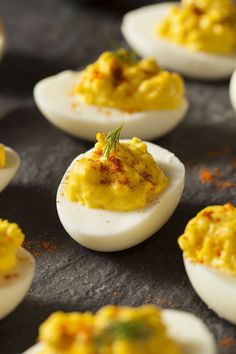 deviled eggs with mustard and seasoning sprinkled on them