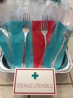 there are forks, knives and spoons in a plastic container with a sign that says sterile utensils