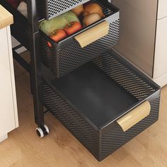 an open drawer in the middle of a kitchen with vegetables and fruit on it's sides