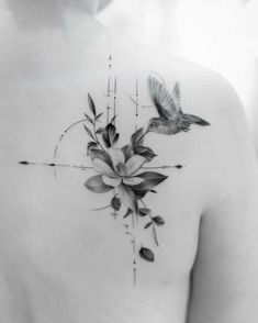 a black and white photo of a woman's back with flowers on it