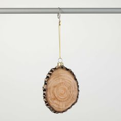 a wooden ornament hanging from a metal bar with a chain attached to it