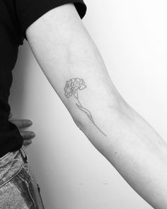 a person with a flower tattoo on their arm