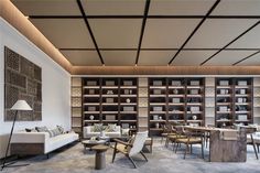 a living room filled with lots of furniture and bookshelves next to each other