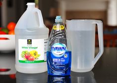 a bottle of water and a container of liquid on a table