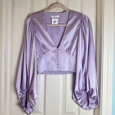 Beautiful Color And Texture Blouse! Never Worn And In Perfect Condition Super Cute For A Special Night! Spring Cropped Satin Blouse, Purple Satin Top For Spring, Fitted Lavender V-neck Blouse, Spring Purple Satin Top, Chic Fitted Lavender Blouse, Elegant Lavender Blouse For Party, Elegant Lavender Party Blouse, Fitted Lavender Blouse For Party, Feminine Lavender V-neck Blouse