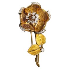 Vintage articulating mechanized flower brooch done in 18K by Merrin of France c. 960’s. Set with approximately 1.45cttw in G-I color Vs1-2 clarity round diamonds, this hard to find piece has a novel feature that allows you to slide the leaves up and down to open and close the petals of the flower. Occasionally available at auction but generally hoarded by collectors. Dimensions/Weight: Brooch measures 2.2” long and 1.1” in diameter when fully opened. Weighs 15g. Condition: All stones are secure and all hallmarks and stamps are present and legible. B-CXXE Piaget Rose, Diamond Flower Brooch, Alexander Calder, Diamond Flower, Antique Jewellery, Flower Brooch, Vintage Jewellery, Belly Button Rings, Brooch Pin