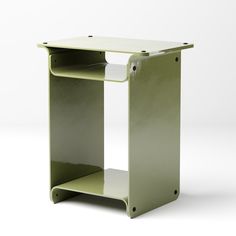 a small green shelf with two shelves on one side and an open drawer on the other