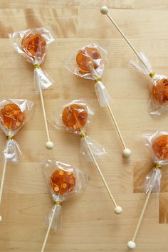 several lollipops wrapped in plastic on a wooden table