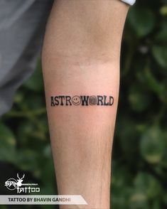 a man with a tattoo on his leg that reads astro world and has the word astro written in it