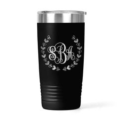 the monogrammed tumbler is shown in black and has an elegant wreath design