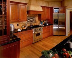 a kitchen with wooden cabinets and stainless steel appliances