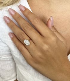 a woman's hand with a diamond ring on it