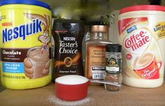 several different types of food sitting on a counter top next to each other, including yogurt and coffee