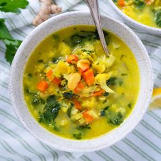 two bowls filled with vegetable soup on top of a table