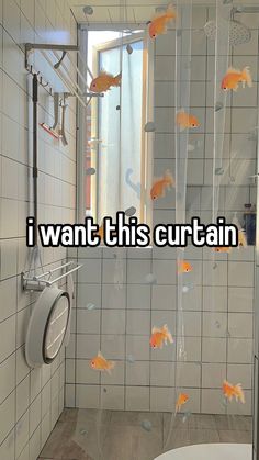 a bathroom with goldfish in it and the words i want this curtain