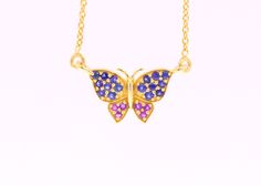 "One of our custom designs and fully handmade with natural gemstones in solid 14k yellow gold - our beautiful, whimsical gemstone butterfly necklace featuring earth mined, bright blue sapphire and purple amethyst. The pendant measures approximately 17mm across. Sturdy lobster clasp and all around excellent craftsmanship on this lovely, nature inspired necklace. The necklace measures 18\" including the chain. Sapphire CTW: approximately .32 Amethyst CTW: appriximately .12 Marked 14k. FREE PRIORIT Luxury Purple Sapphire Jewelry, Blue Butterfly Fine Jewelry, Sapphire Multi-stone Necklace For Gifts, Sapphire Multi-stone Necklace As A Gift, Sapphire Multi-stone Necklace Perfect As A Gift, Handmade Yellow Gold Sapphire Jewelry, Fine Jewelry Sapphire Jewelry In Purple, Fine Jewelry In Purple Sapphire, Handmade Tanzanite Yellow Gold Jewelry