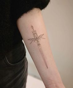 a woman's arm with a flower tattoo on the left side of her arm