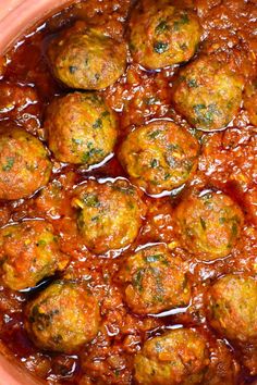 some meatballs are covered in sauce in a pot