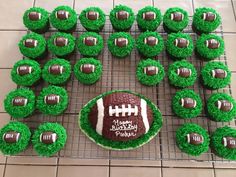 cupcakes with green frosting and football decorations