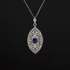 This gorgeous vintage inspired sapphire and diamond pendant is beautifully designed to capture the glamour and romantic style of vintage design! The intricate cut outs and milgrain gives this pendant a touch of vintage flair and an air of Art Deco glamour. Finished with fine milgrain details, and a diamond accented bail, the setting perfectly sets off the rich blue sapphire center.The sapphire is a well saturated blue hue. The diamonds are brilliantly white, graded G-H for color. Graded SI1-SI2 Art Deco Glamour, Saturated Blue, Art Deco Necklace, Sapphire Color, Natural Earth, Romantic Style, Vintage Diamond, Sapphire Diamond, Vintage Stil