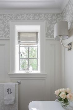 a bathroom with a sink, toilet and window