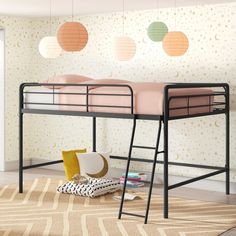 a bunk bed sitting on top of a rug next to a wall mounted light fixture