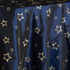 a blue table cloth with gold stars on it and a black tablecloth behind it