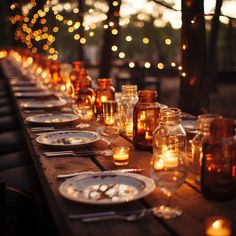 a long table is set with candles and plates for an outdoor dinner or gathering in the evening