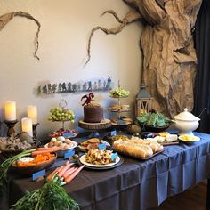 a table topped with lots of food and candles