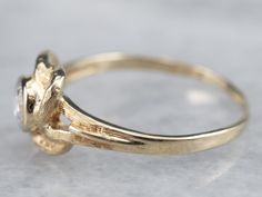 Two textured strands of gold are carefully shaped into a lover's knot in this vintage ring! We love the classic style of the piece, and the brilliant sparkling diamond set at the very center, making this a sweet little ring suitable for any occasion!Metal: 10K Yellow Gold Gem: Diamond .25 Carats, G in Color, SI1 in ClarityGem Measurements: 3.8 mm, Round Ring Size: 6.50Marks: “10K” Stamped on the inside band Knot Engagement Ring, Diamond Knot Ring, Diamond Knot, Sparkling Diamond, Knot Ring, Round Rings, Diamond Set, Vintage Ring, Vintage Diamond