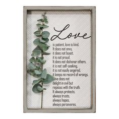 a wooden frame with a plant in it and the words love written on it's side