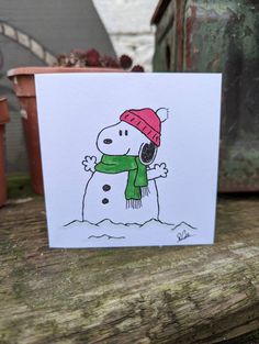 a card with a drawing of a snowman on it