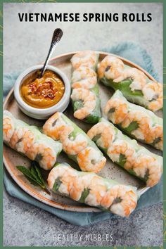 shrimp spring rolls on a plate with dipping sauce