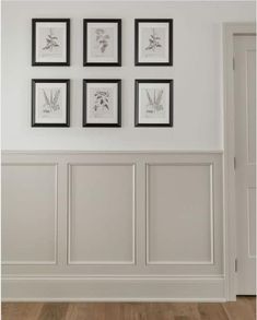 a white room with framed pictures on the wall