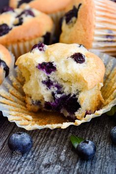 some blueberry muffins sitting on top of a wooden table