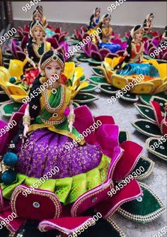 an elaborately decorated table with colorful decorations and figurines in the shape of flowers