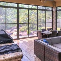 an outdoor living area with couches and tables