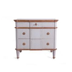 an old dresser with wooden handles and drawers on the bottom, in white and brown